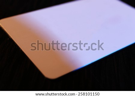 Plastic discount card on wooden table background
