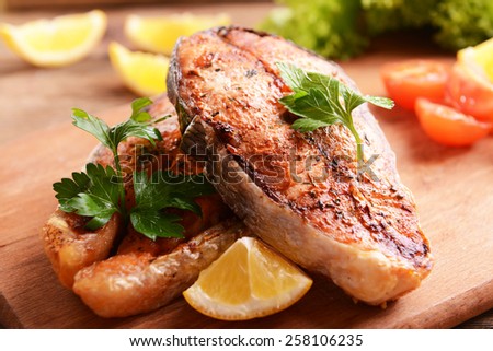 Tasty baked fish on table close-up