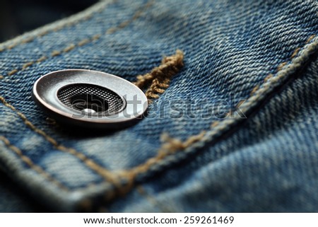 Metal button on clothes close up