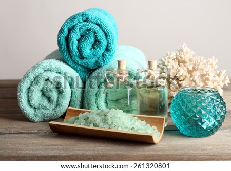 Spa composition with towels and sea salt on light background