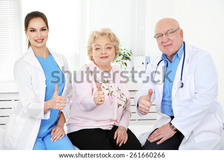 Happy doctors and patients in hospital clinic