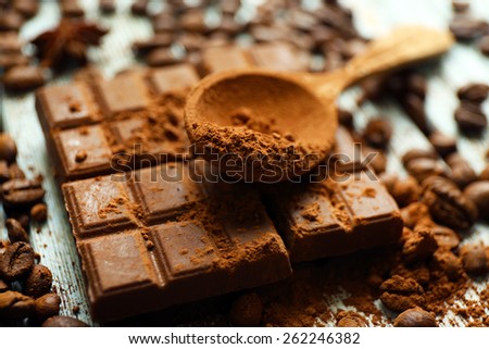 Still life with chocolate, grains and cocoa on wooden background