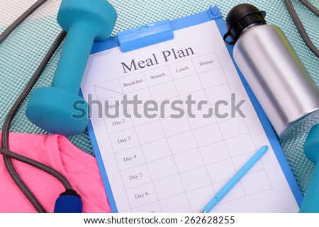 Meal plan and sports equipment top view close-up