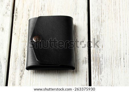 Hand made leather man wallet on white wooden background