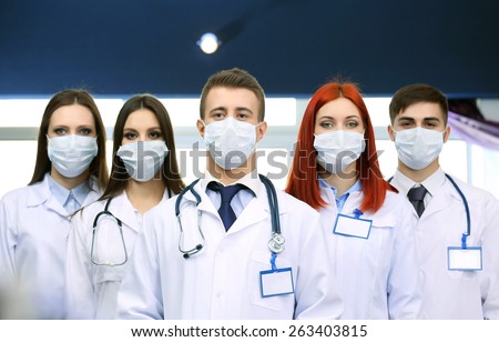 Medical workers in medical masks in conference room