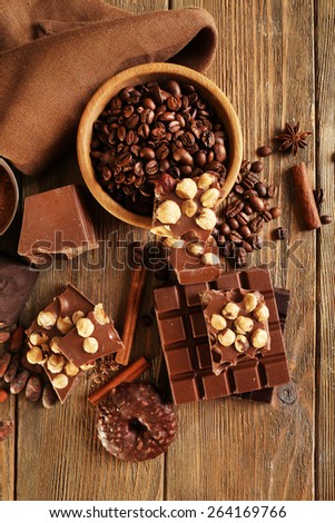 Still life with set of chocolate on wooden table, top view
