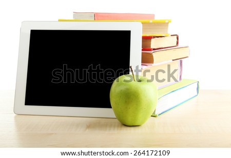 Books, PC tablet and apple on desk, isolated on white