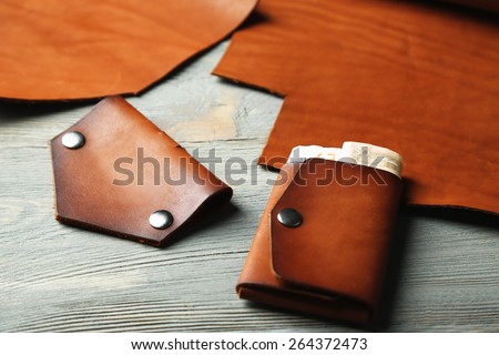 Hand made leather man accessories on wooden background
