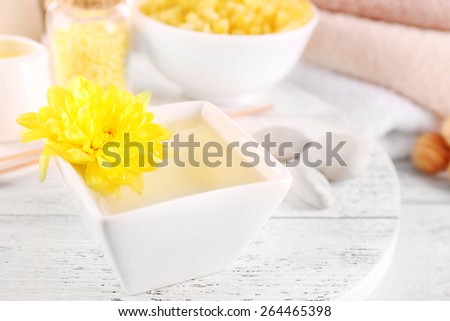 Bowl of spa aroma water on wooden table, closeup