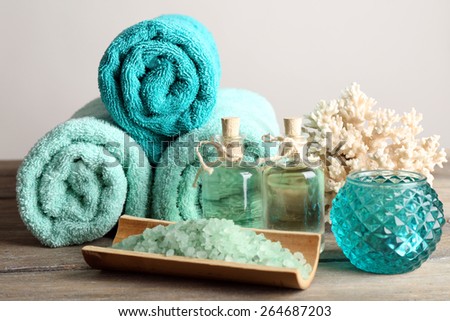 Spa composition with towels and sea salt on light background