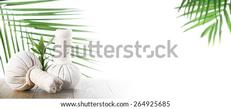 Spa compress balls with green leaves isolated on white