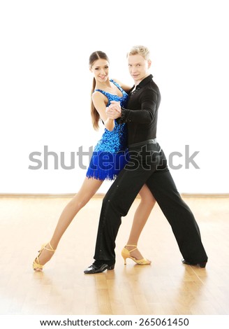 Beautiful couple in active ballroom dance, indoors