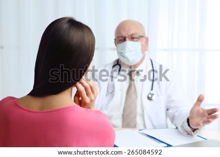 Professional doctor receiving patient in his office on white curtain background