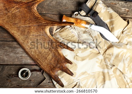Hunting gear on wooden board, top view