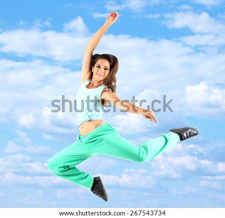 Jumping woman on sky background