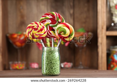Colorful candies in jar on table in shop
