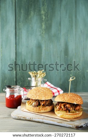 Tasty sandwich on cutting board, on color wooden background. Unhealthy food concept