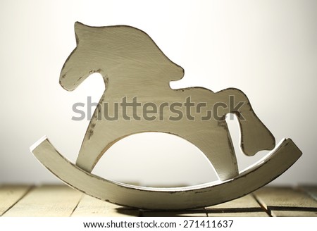 Decorative rocking horse on wooden table, close up
