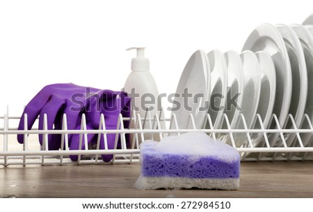 Plates in foam with gloves and cleanser on table close up