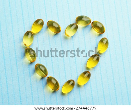 Heart of cod liver oil, on blue background