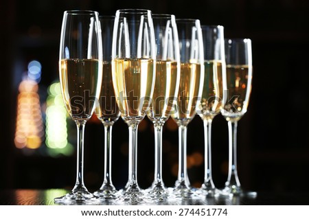 Glasses of champagne on bar background