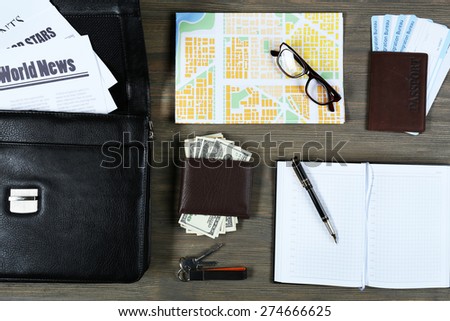 Set of business trip stuff on wooden background