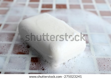 Soap with bubble on mosaic tiles background