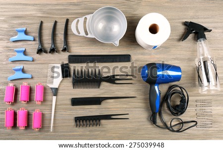 Hairdressing tools on wooden background