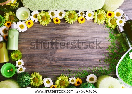 Beautiful spa composition with flowers as frame on wooden background
