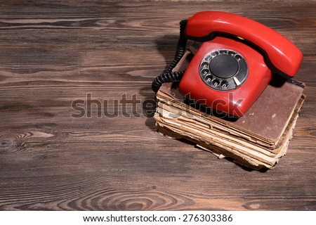 Retro red telephone on table close-up
