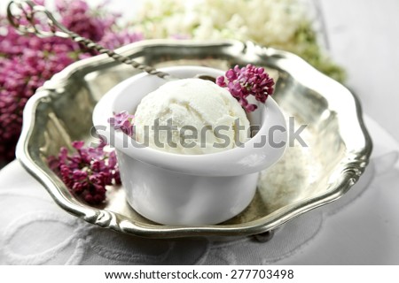 Beautiful composition with tasty ice cream and lilac flowers