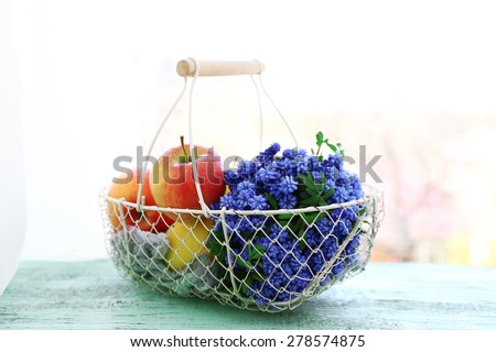 Beautiful bouquet of muscari - hyacinth with fruits in metal basket on windowsill