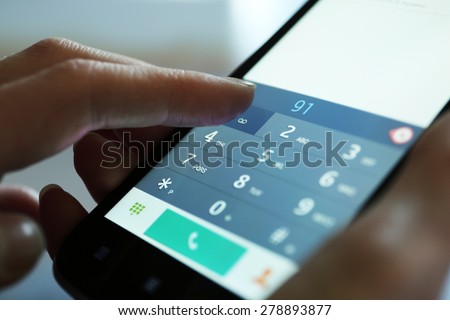 Finger touch number on smartphone to make a call, close up