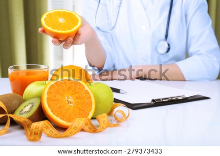 Nutritionist doctor with fruits in office