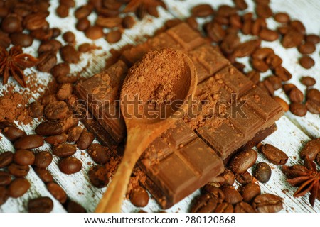 Still life with chocolate, grains and spice on wooden table, closeup
