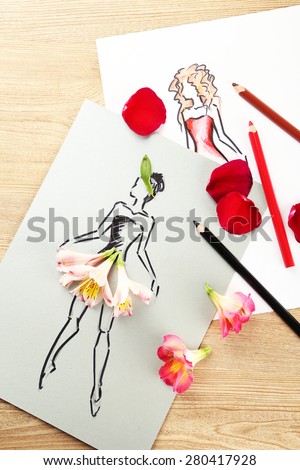 Picture with flower petals and pencils on wooden table