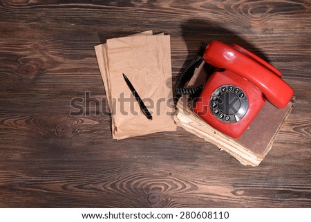 Retro red telephone on table close-up