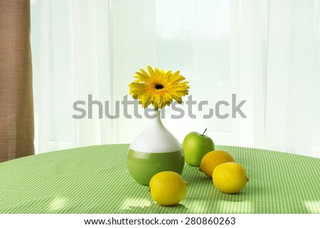 Color gerbera with fruits on table on curtains background