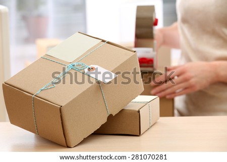 Woman packs parcel in post office