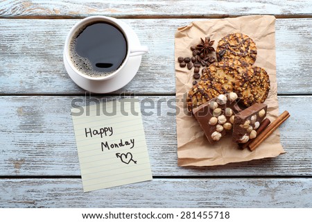 Cup of coffee with fresh cookies and Happy Monday massage on wooden table, top view