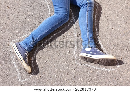 Dead woman laying on asphalt