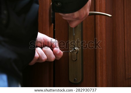 Burglar breaking into house
