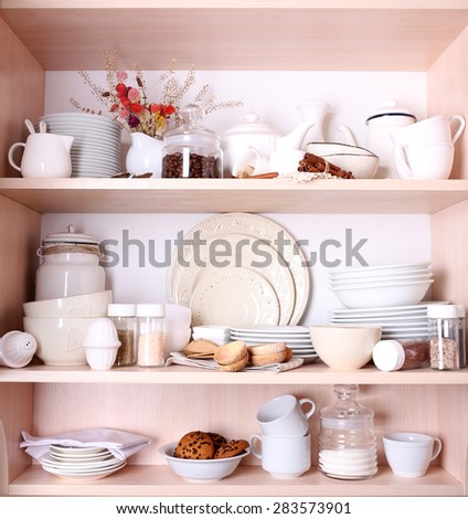 Kitchen utensils and tableware on shelves