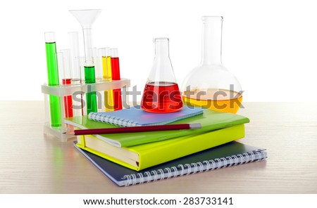 Desk with books and test tubes isolated on white