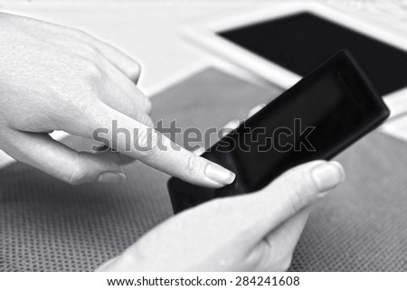Woman with mobile phone and tablet, close-up