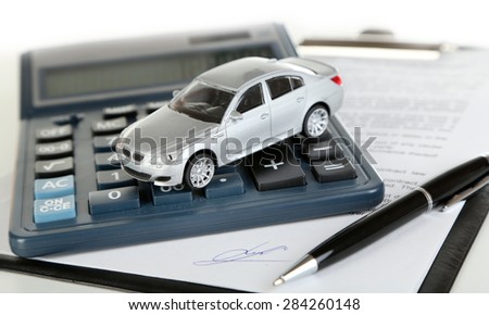 Tablet, calculator and toy car isolated on white