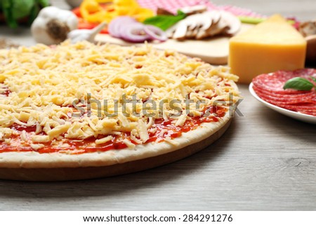 Raw pizza on table close up