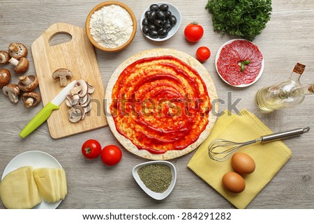 Cooking pizza on wooden table, top view