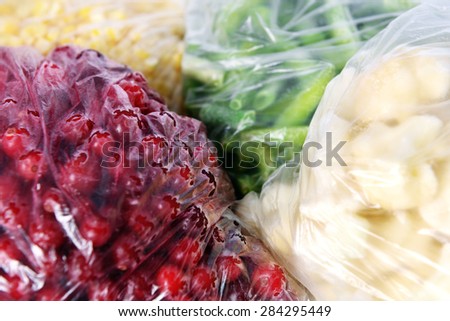 Frozen berries and vegetables in bags close up