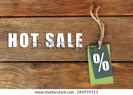 Sale tag on wooden background